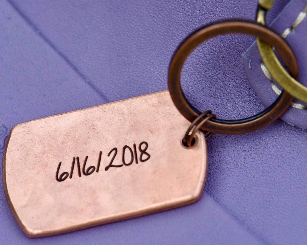 Back view of copper keychain with custom engraved wedding date.