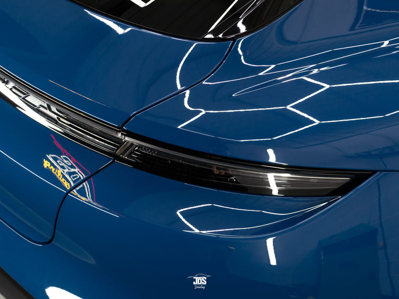 Blue Porsche bonnet reflecting hexagon lights after a ceramic coating