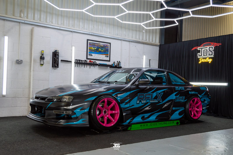 Car with a blue and pink livery in the studio
