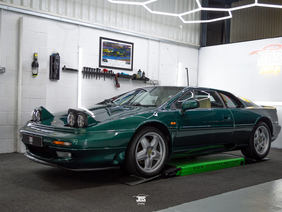 Classic sports car with its engine cover open in the studio