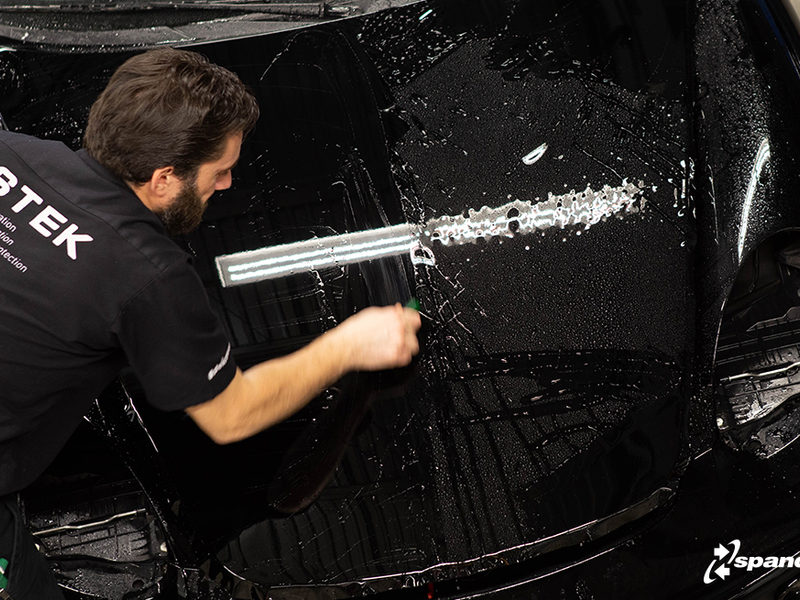 Paint protection film being fitted in the PPF booth