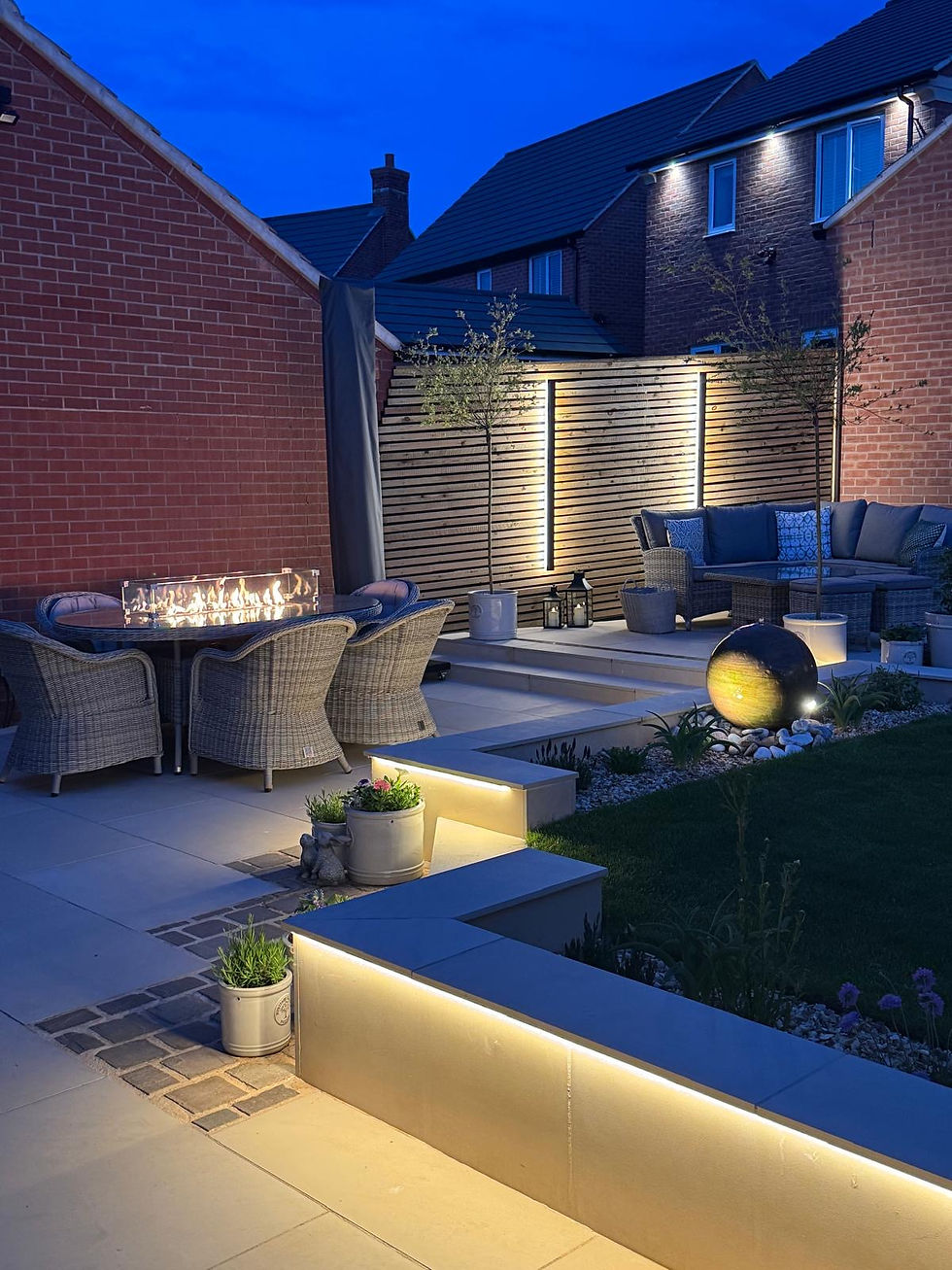 Stylish outdoor garden lighting setup with LED strip lights and porcelain paving