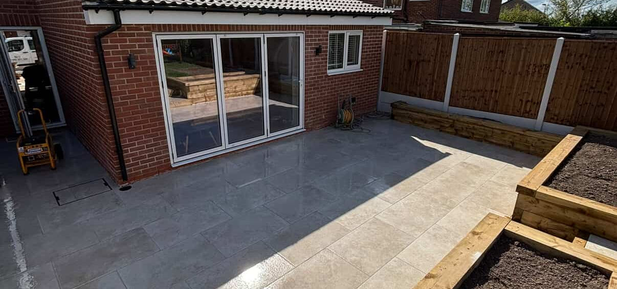 New patio with timber raised planting beds in a landscaped back garden