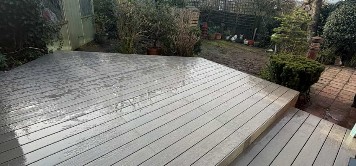 Raised composite decking patio in modern residential garden