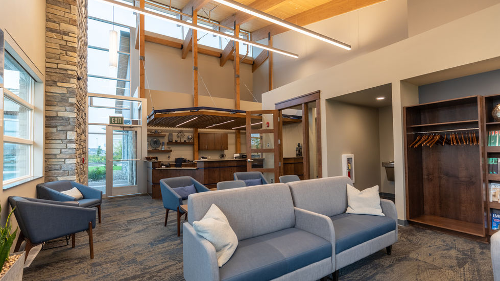 Lobby/ waiting area with a high exposed glulam ceiling.