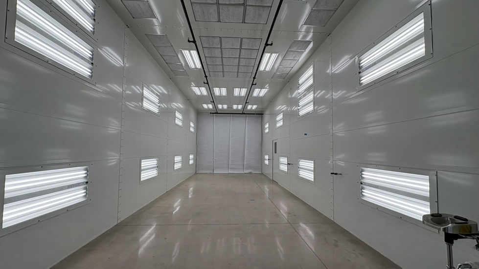 Highly reflective paint booth with bright even lighting and a strong ventilation system. 