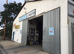 street view of original building, large metal roll-up door, auto body shop