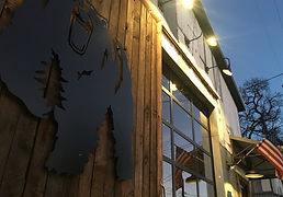 street view of building with large bear on wooden door