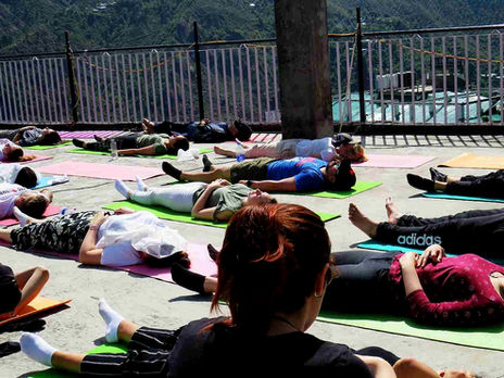 Yoga instructor guiding trainees in a Yoga Alliance certified yoga teacher training course in Dharamshala, India.