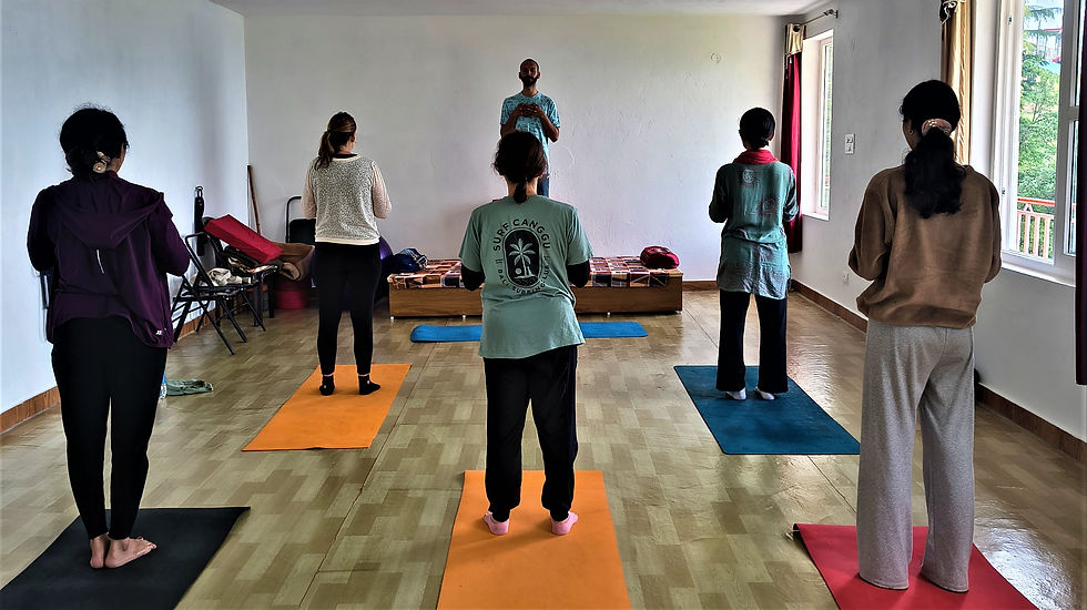 International yoga students practicing authentic yoga teacher training in the Himalayas with breathtaking mountain views.