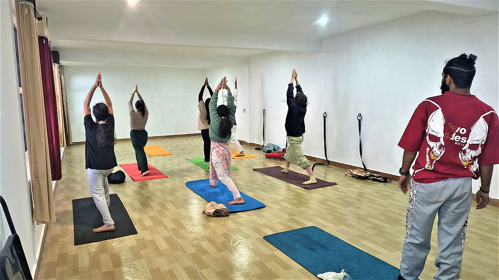 Yoga teacher training session in the Himalayas with students practicing asanas outdoors