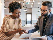two business people reviewing assurance service options