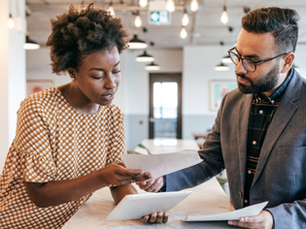 two business people reviewing assurance service options