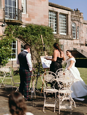 Professional photo of me doing a live wedding painting at Ardgowan House