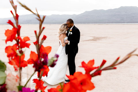 Couple embraces at their wedding, Dry Lake Bed Ceremony, mountains in background, TIMELESS CONNECTION