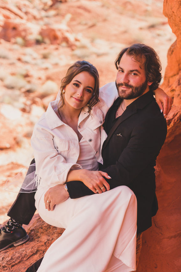 Couple poses in desert; man with beard, woman with jacket Valley of Fire Ceremony.