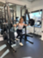 a woman doing a chest exercise in a gym