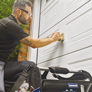 A student learns to open a broken garage door lock ar Cornwall and Devon Locksmith Training