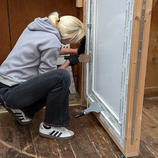 Female locksmith dealing with a failed multi point door
