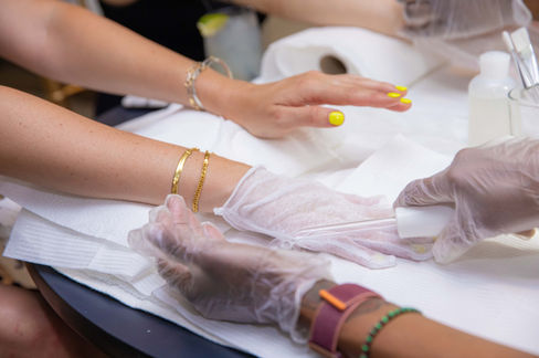 Employees enjoying facial and skincare services during a corporate wellness event.
