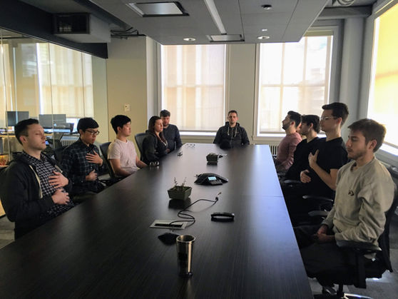 Employees practicing meditation as part of a workplace wellness program