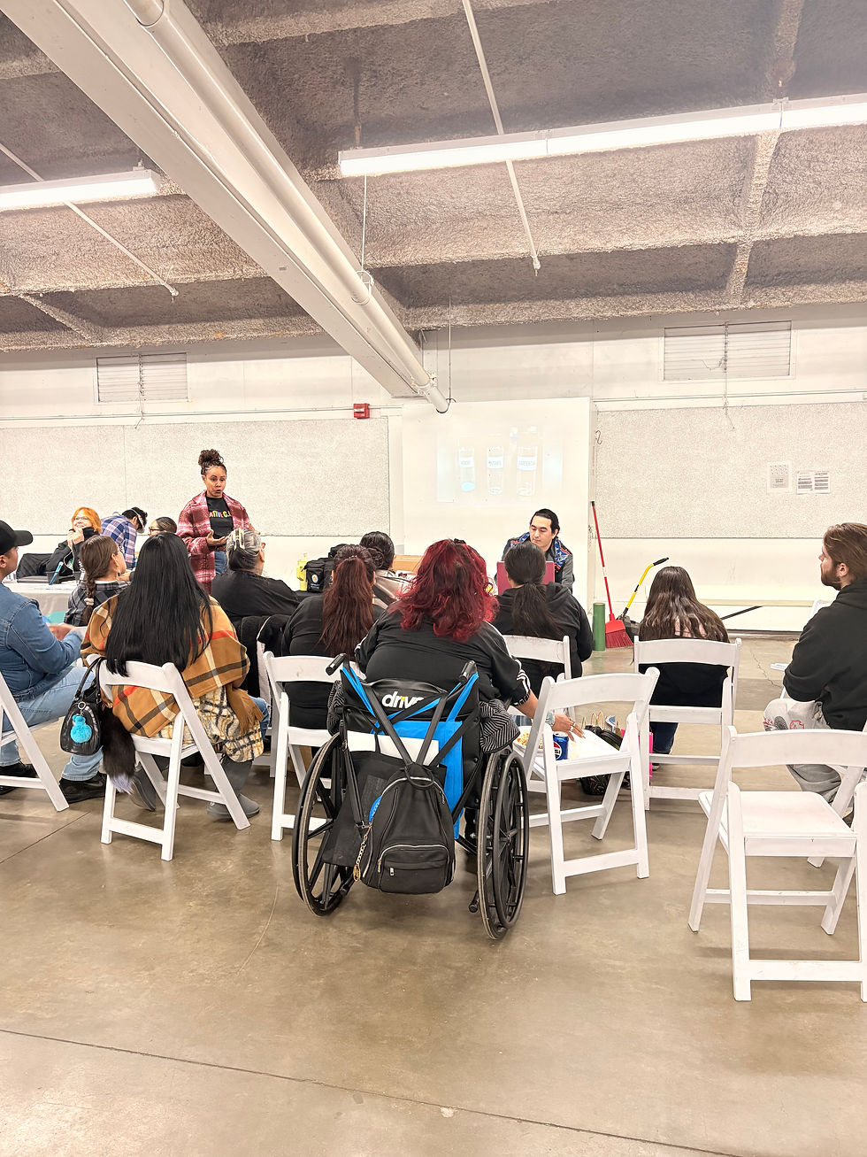  Community attends an educational session discussing the potency of fentanyl compared to heroin and other substances, highlighting crucial information through a presentation.