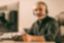 middleaged-call-center-operator-looking-camera-bearded-man-with-headset-talking-with-clien