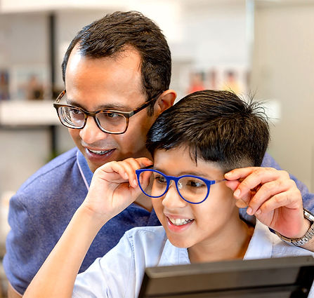 Visual Eyes young patient trying on glasses with father