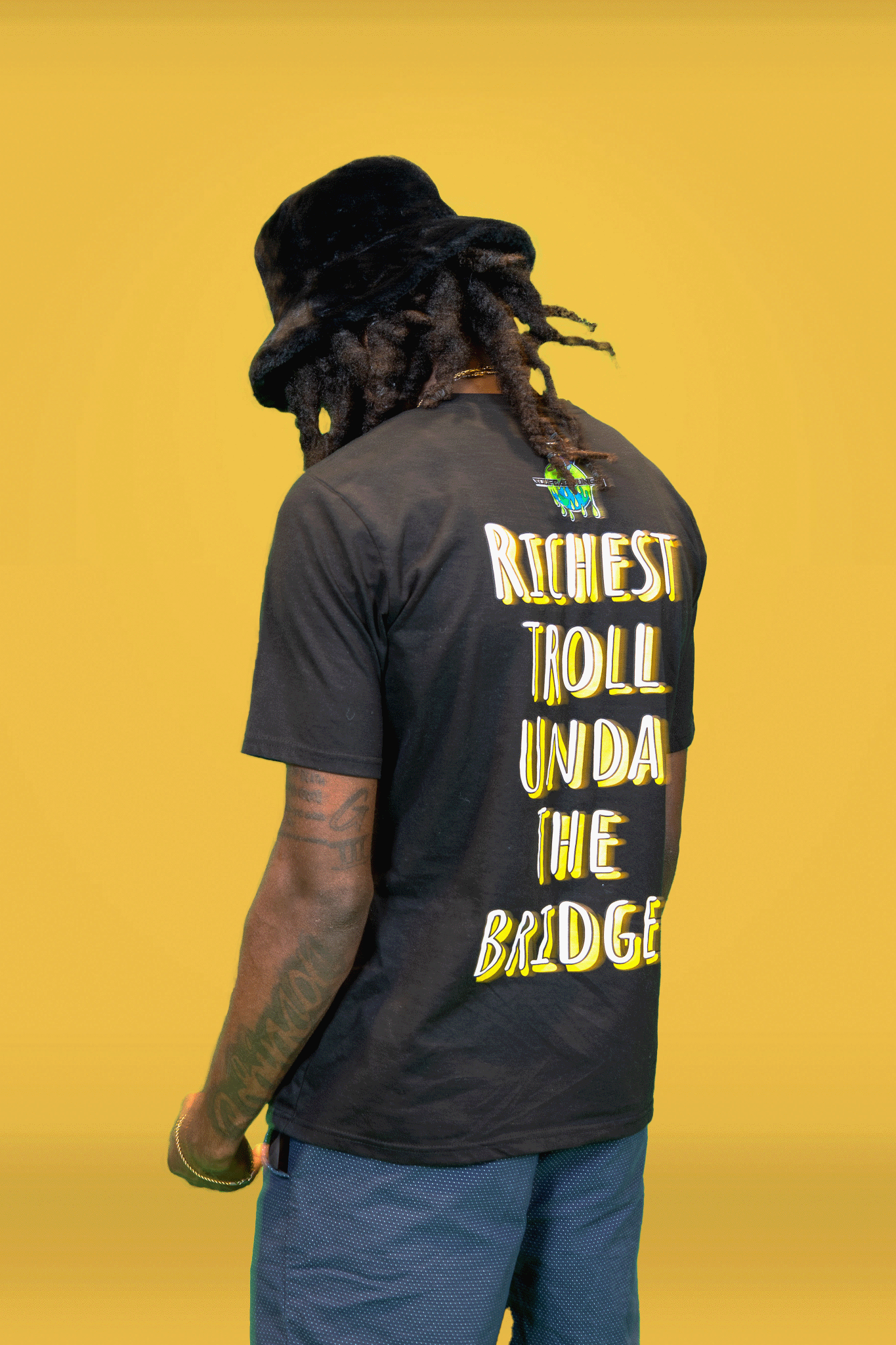 Black male standing in front of yellow backdrop