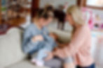 Lactation Consultant with mother breastfeeding