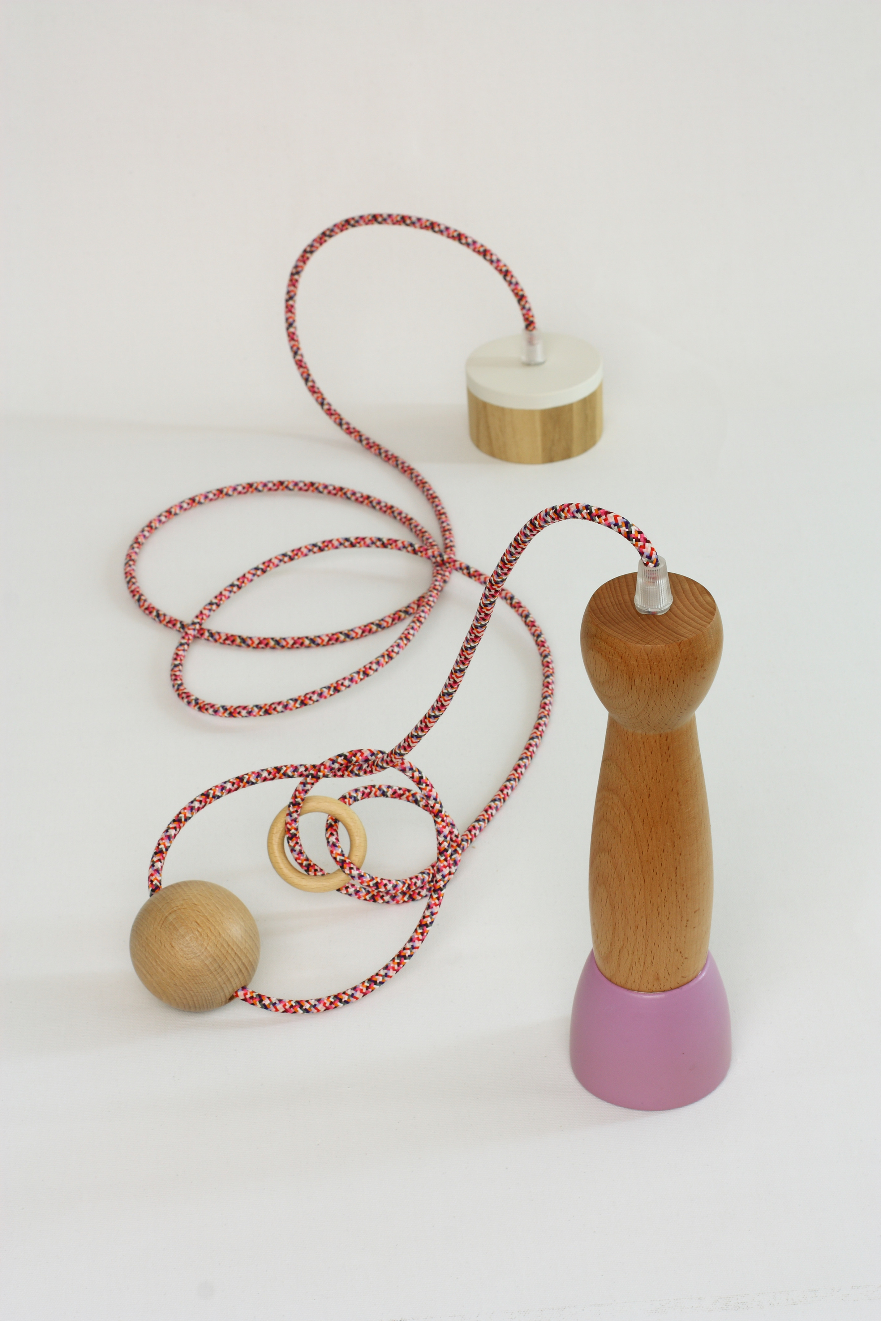 Wooden pendant light with pink base and red and white cable. Silhouette Pendant. atelier28