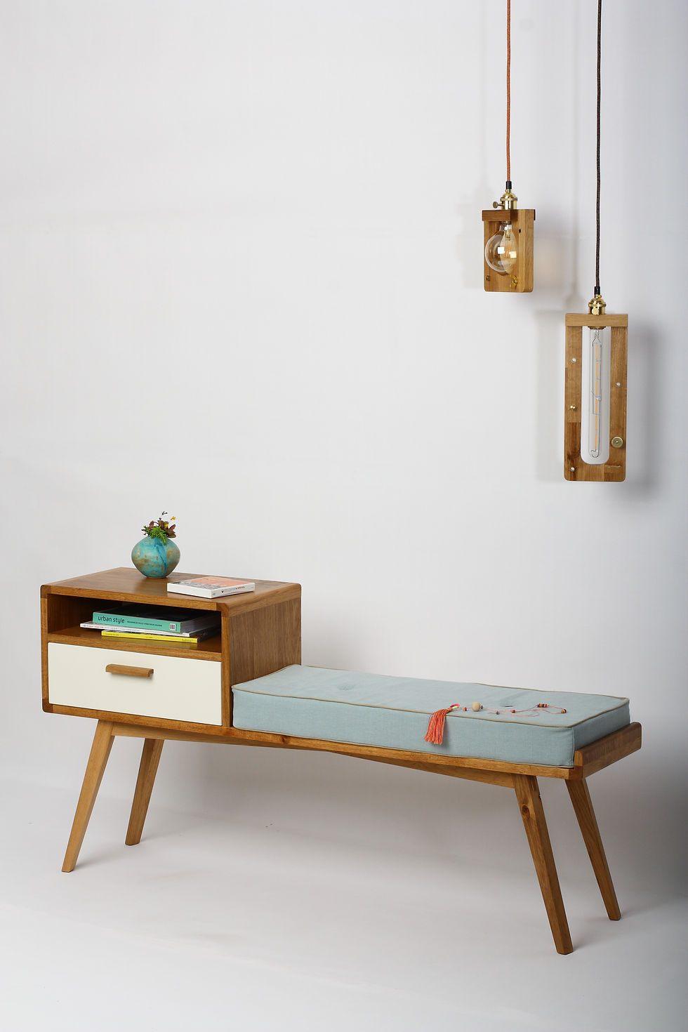 Thumbnail: Wooden bench with storage and drawer, blue cushion, lamps, atelier28.