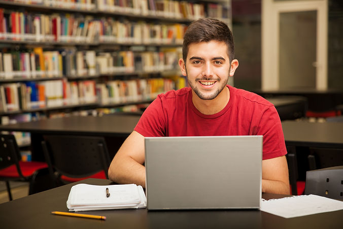 portrait-attractive-latin-student-doing-some-school-work-with-laptop-library.jpg