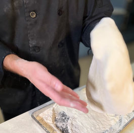 Gently lift Doctor Dough and pass the dough back and forth between your open flat hands