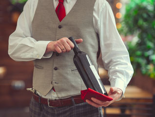 waiter holding wine bottle