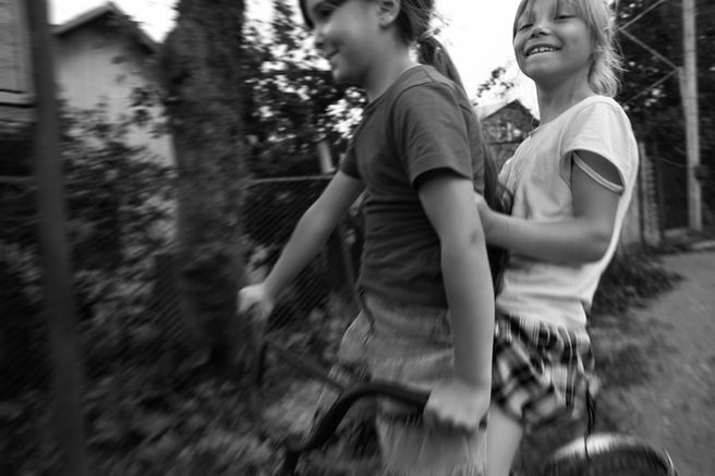 Two Molokan girls whizz back and forth on a bicycle, laughing at the idea of being photographed.

Armenia, 2024.