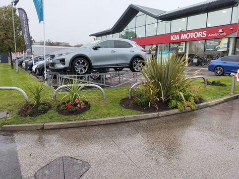 Maintained grass and planted areas at a commercial motor dealership