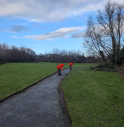 Total Care Grounds Maintenance team carrying out grounds maintenance in high-visibility workwear
