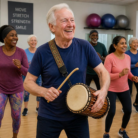 Caucasian British man in his 70s joyfully playing a handheld African talking drum with a s