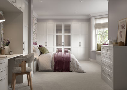 Light grey bedroom with shaker-style integrated wardrobes.