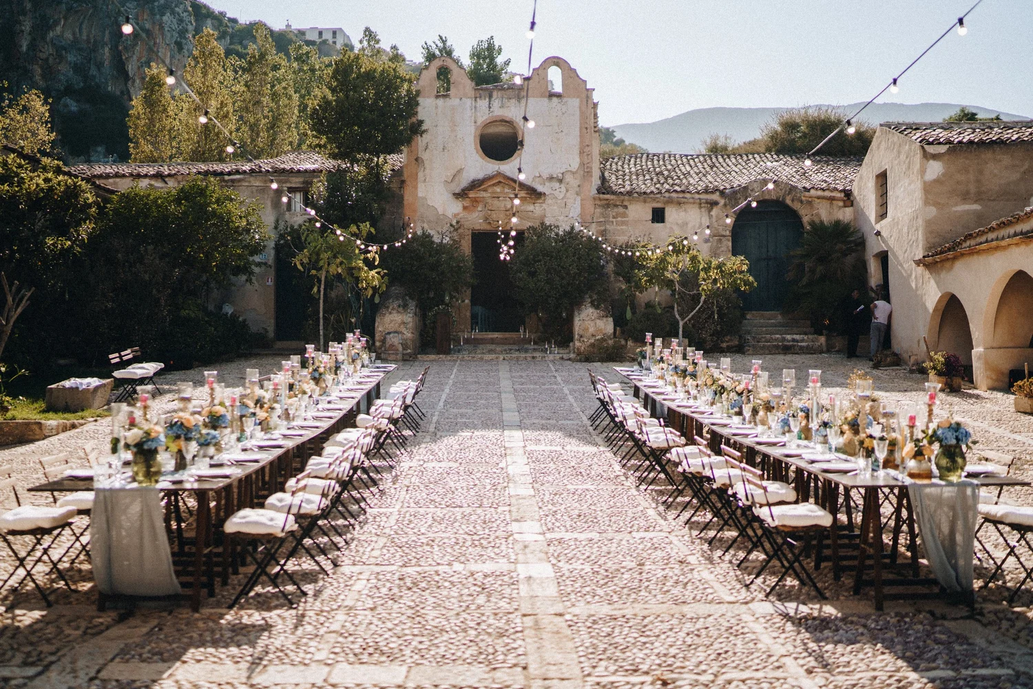 long reception tables in Italy wedding at Tonnara di Scopello — Sicily Wedding Venue