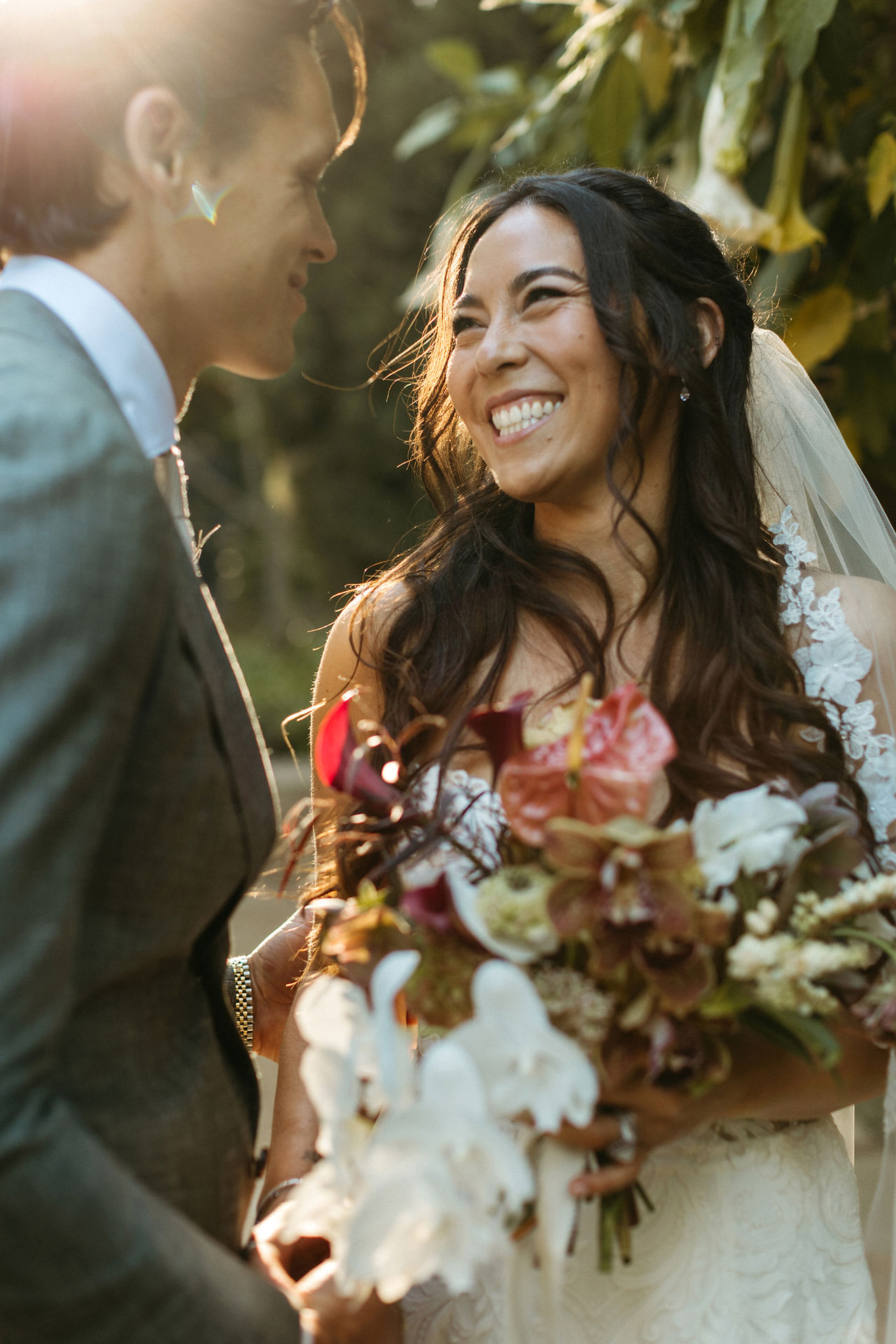 couple expressing happiness on their wedding day, smiling at one another