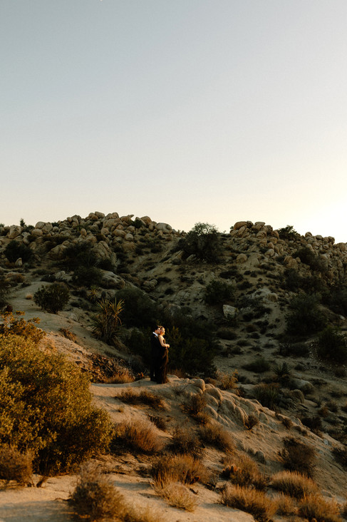 bride and groom embracing during sunset in joshua tree elopement