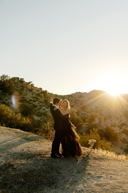 bride and groom dancing during sunset in joshua tree elopement