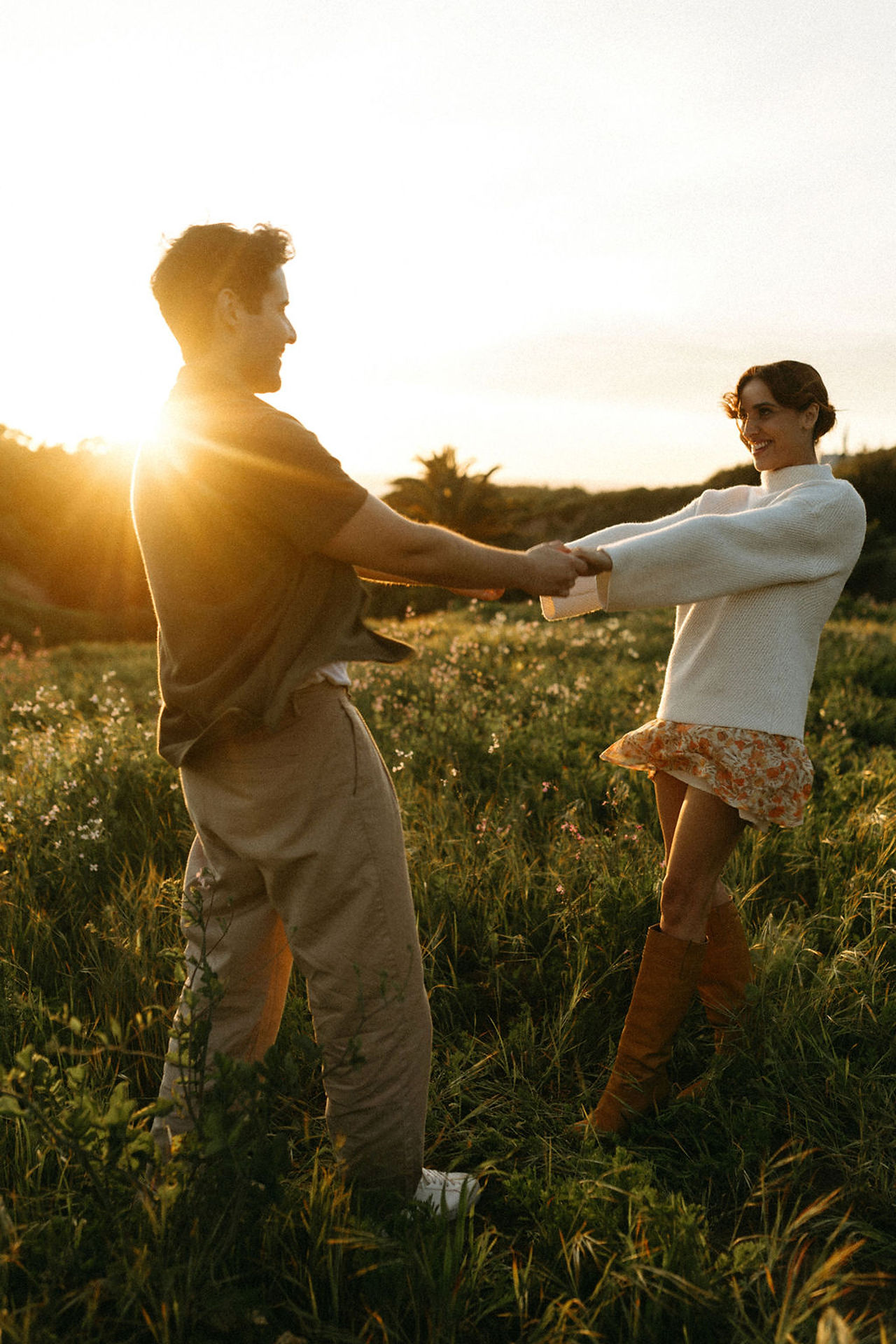 palos verdes engagement session couple spinning around in a field