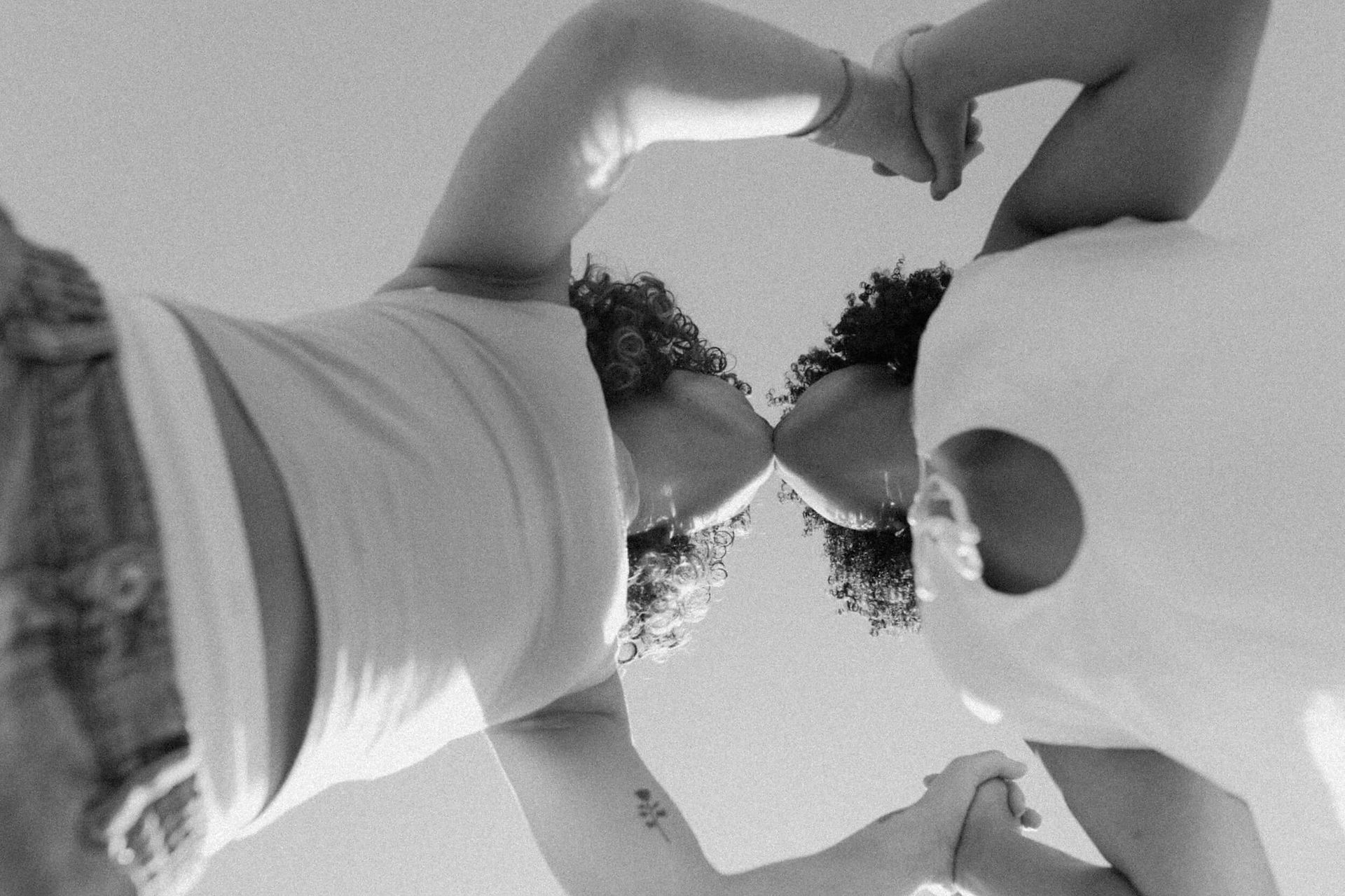photographing up at couple embracing by los angeles lgbtq+ photographer