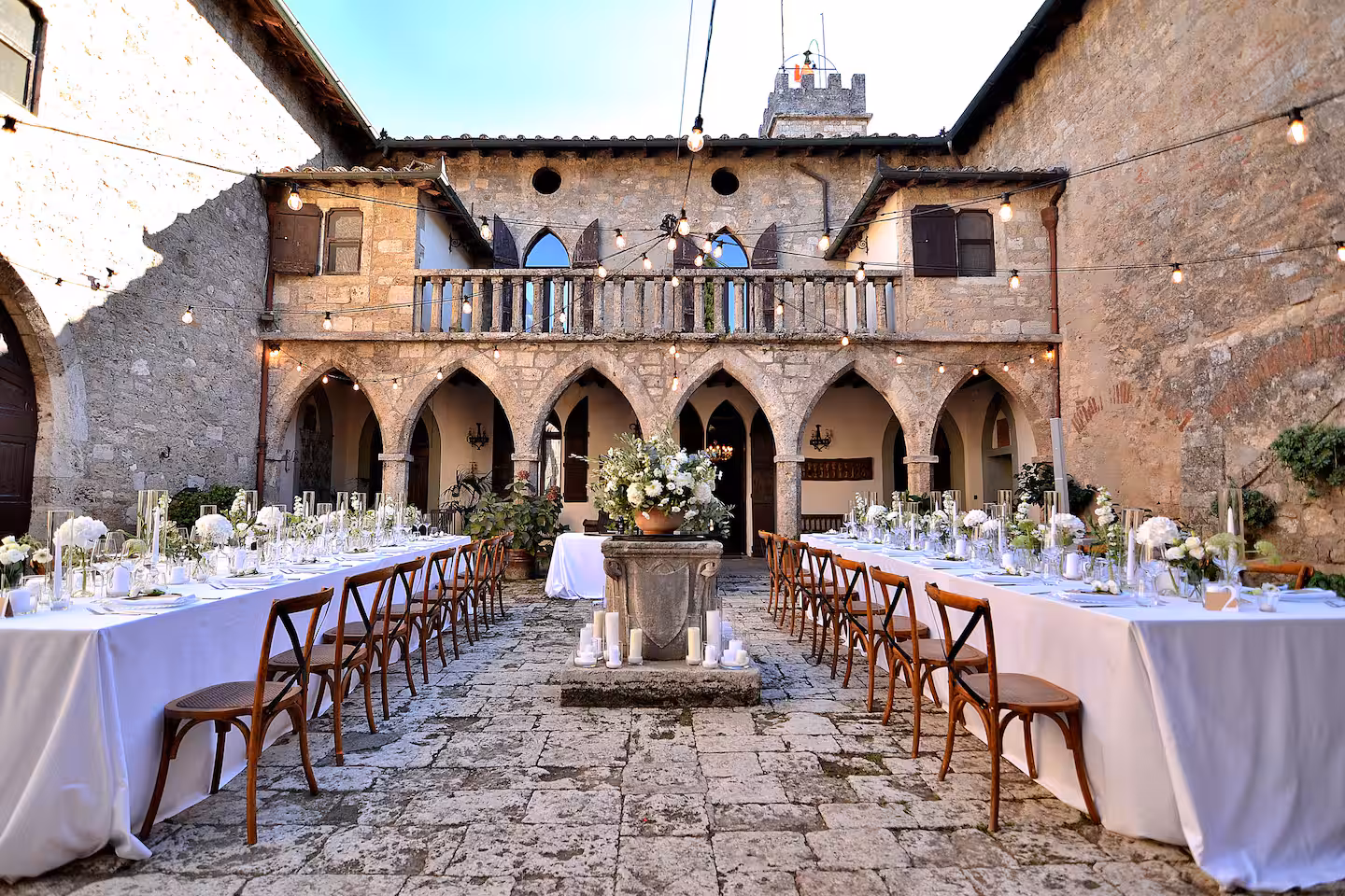 Courtyard dinner reception at castle wedding venue in Tuscany, Italy