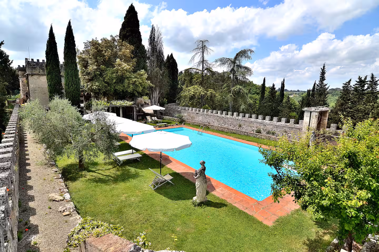 Pool and gardens at castle wedding venue in Tuscany, Italy