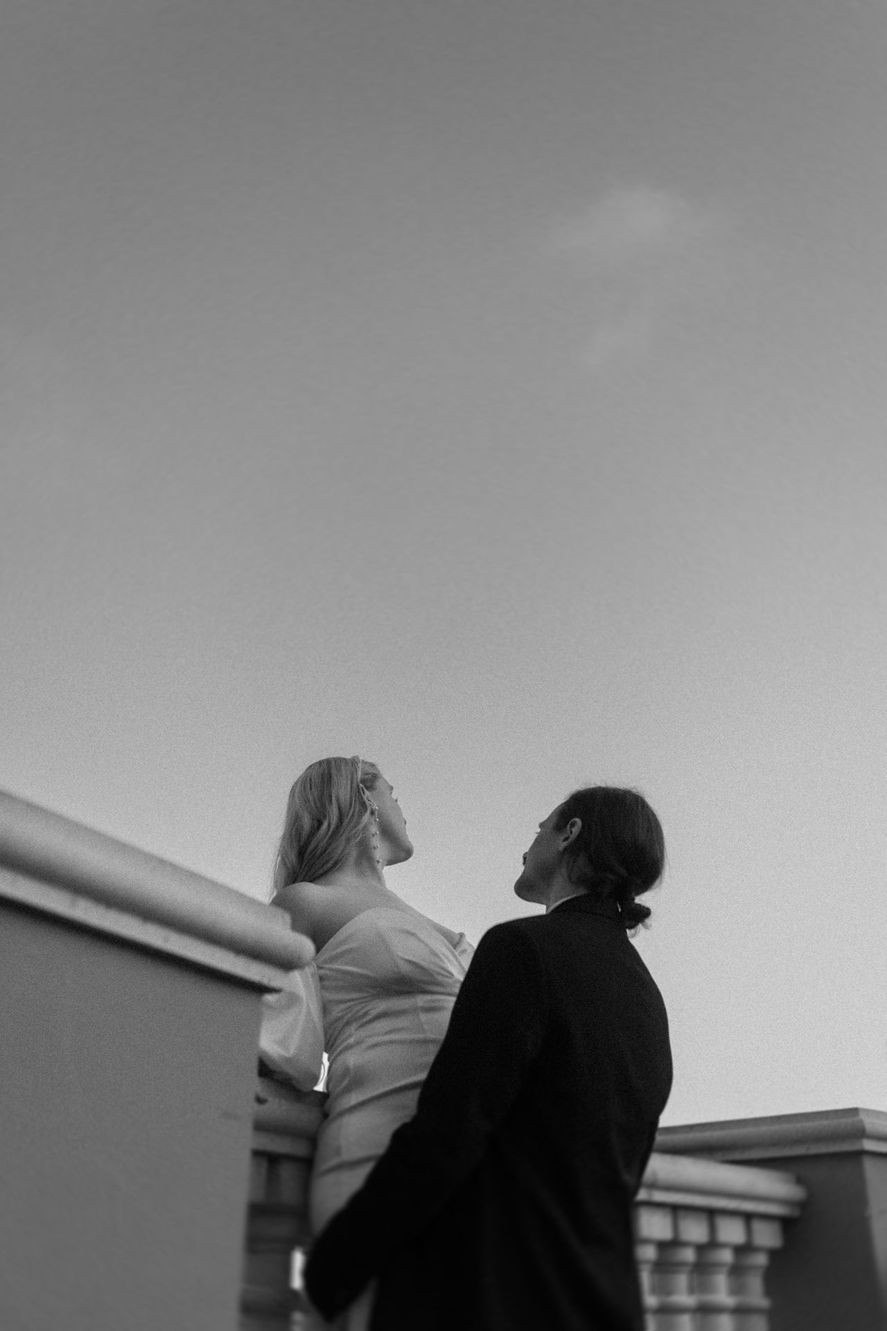 bride and groom leaning over balcony at italian villa elopement