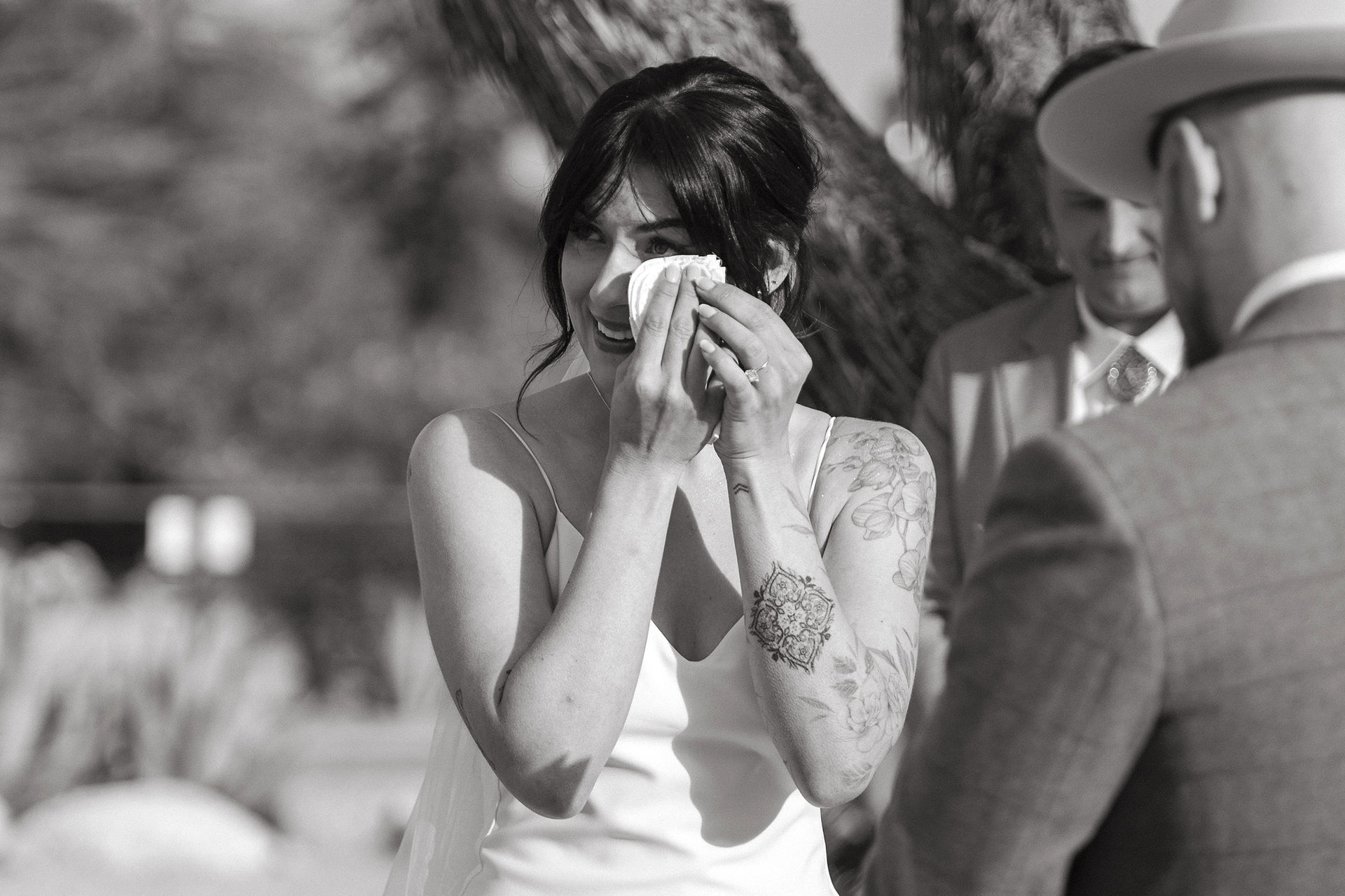 close-up of bride wiping away tears during wedding ceremony at rimrock ranch
